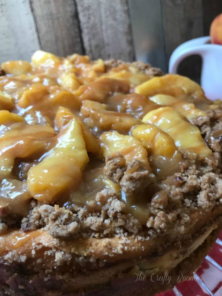 A creamy peach crumble cheesecake with a caramel topping is sure to be a hit on your dessert table.